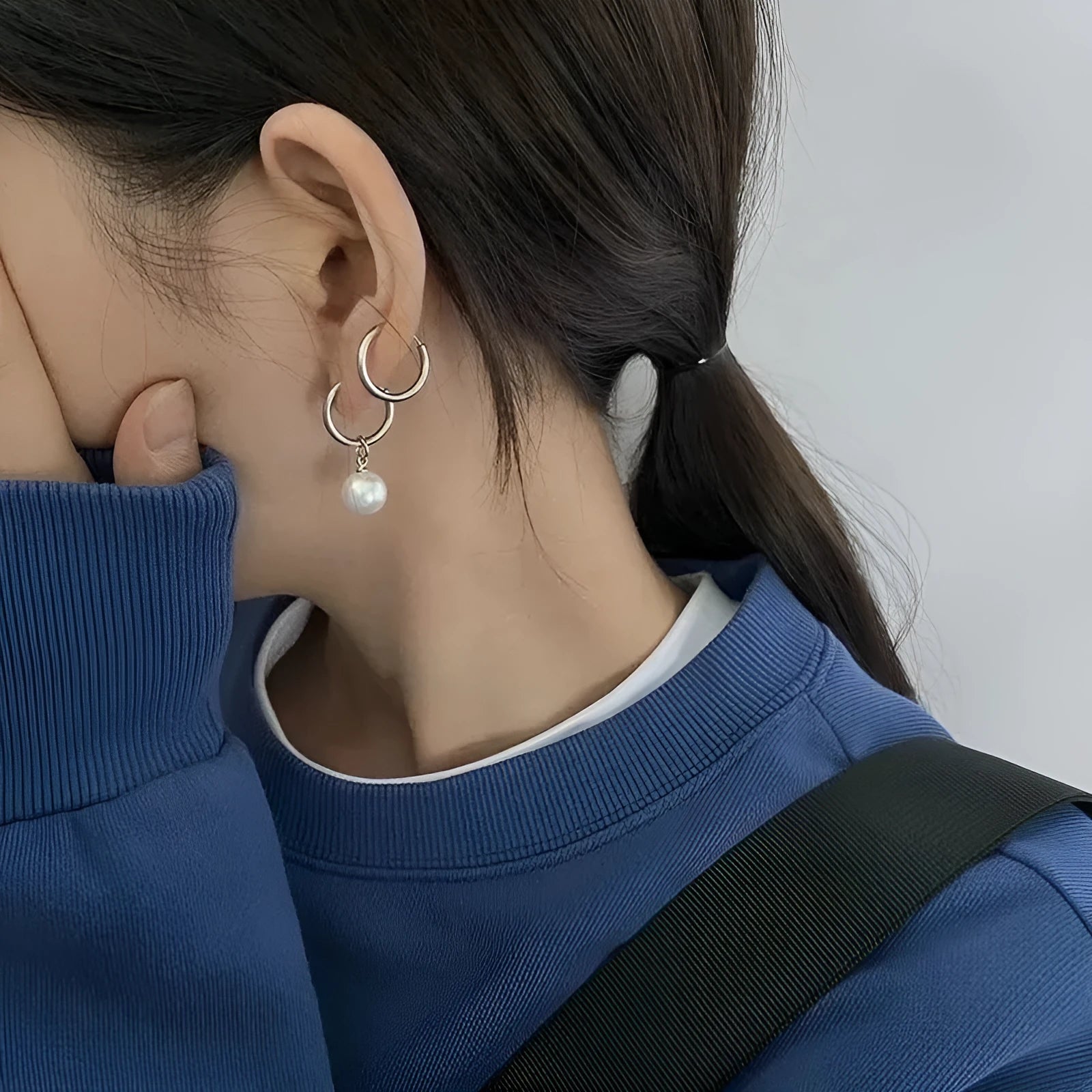 A pair of women's geometric alloy earrings with round pearl details and titanium steel posts.
