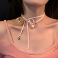 Women's ribbon love pendant fashion necklace on a clavicle chain, showing the alloy electroplated finish.
