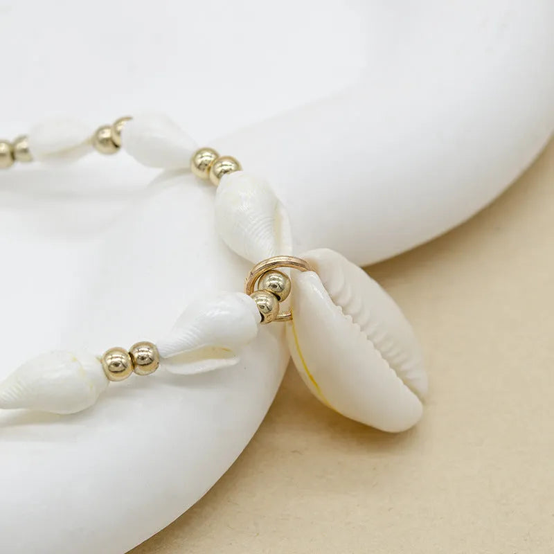 White conch shell necklace with mother pearl pendant on a regular electroplated chain.