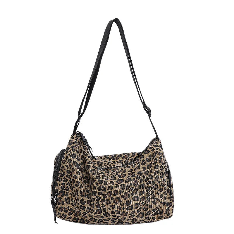 Leopard print cross-body messenger bag with shoulder strap and stitching details