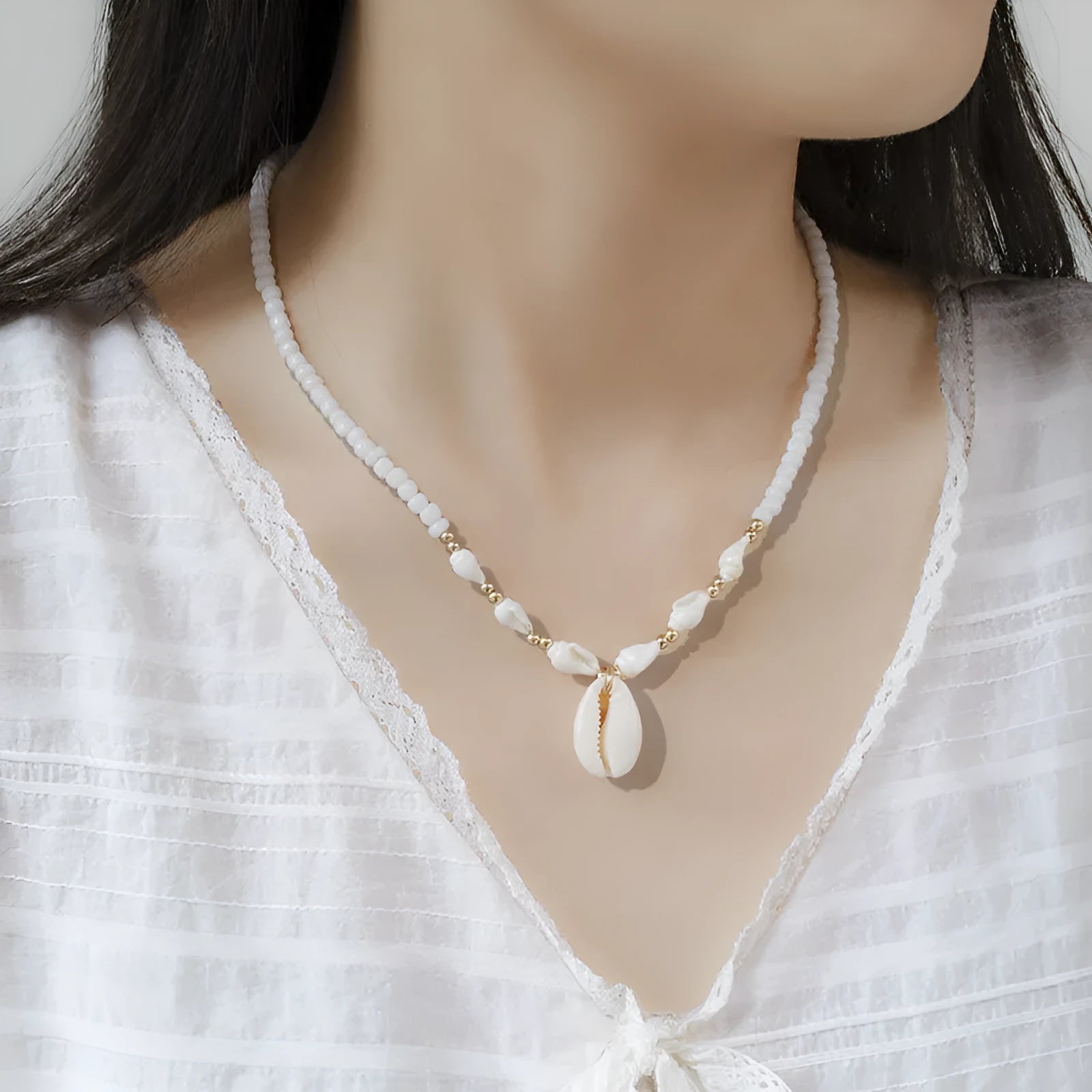 White conch shell necklace with mother pearl pendant on a regular electroplated chain.