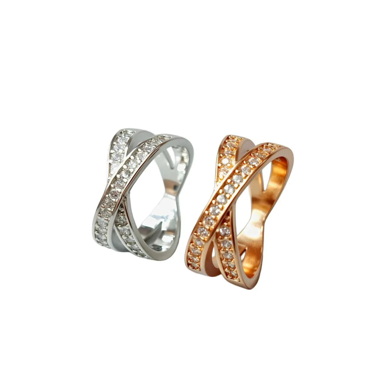 Close-up of a silver cross ring with micro-inlaid zircon details on a simple band.