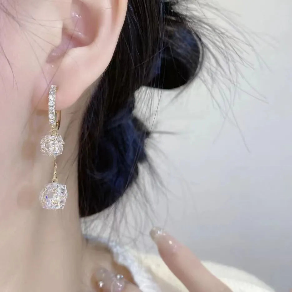 Women's silver tone drop earrings with tassel ball and rhinestone ball double pendant design
