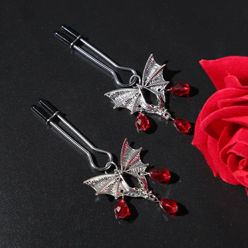 Silver bat nipple clamp with ruby design and adjustable pressure mechanism