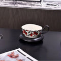 Retro ceramic coffee cup and saucer set in black or orange with medieval design