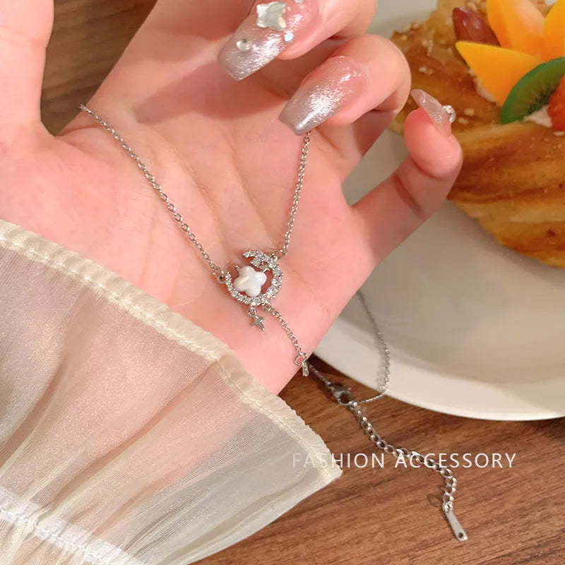 Gold celestial necklace with star and moon pendant on delicate clavicle chain