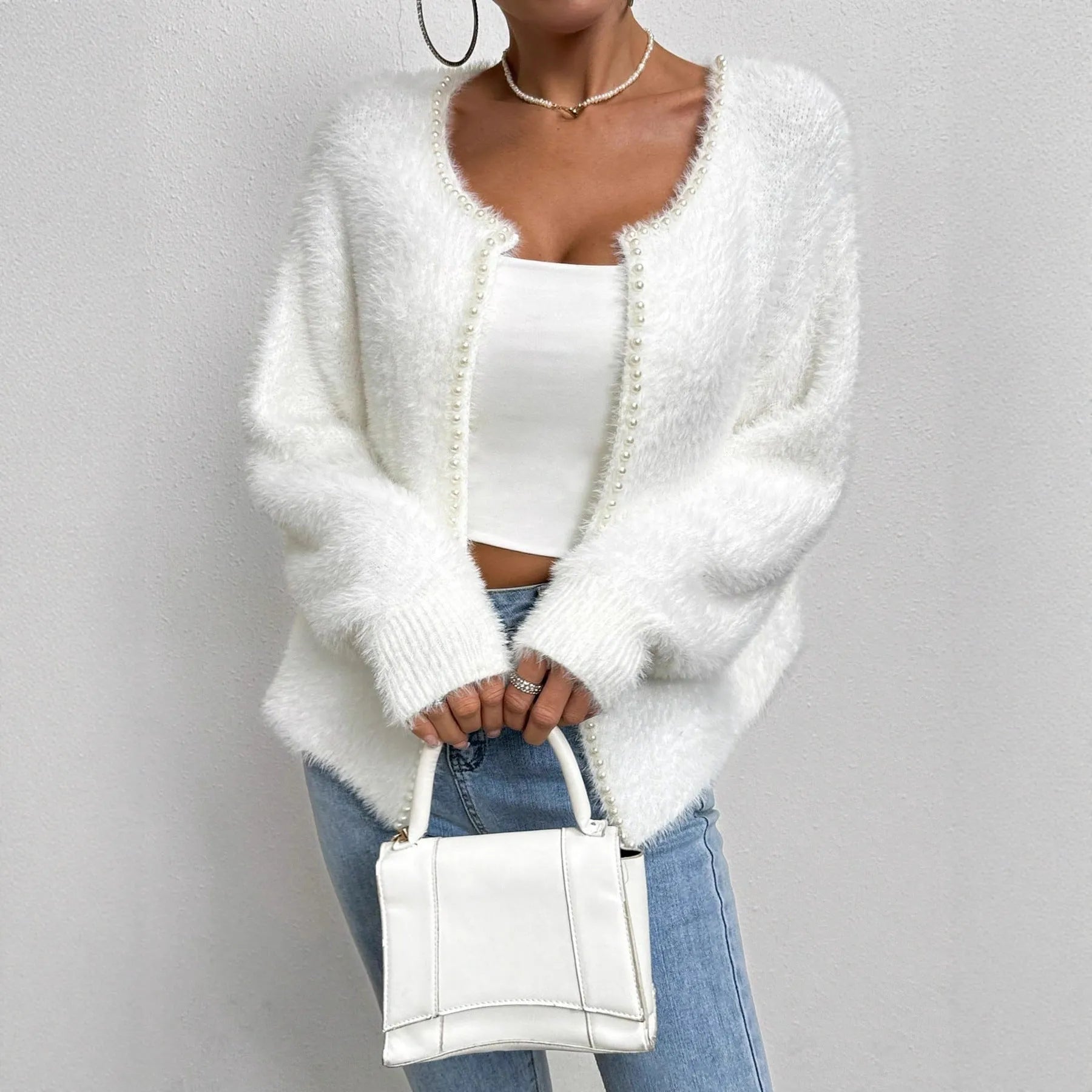 White women's V-neck cardigan with regular length polyester knit construction