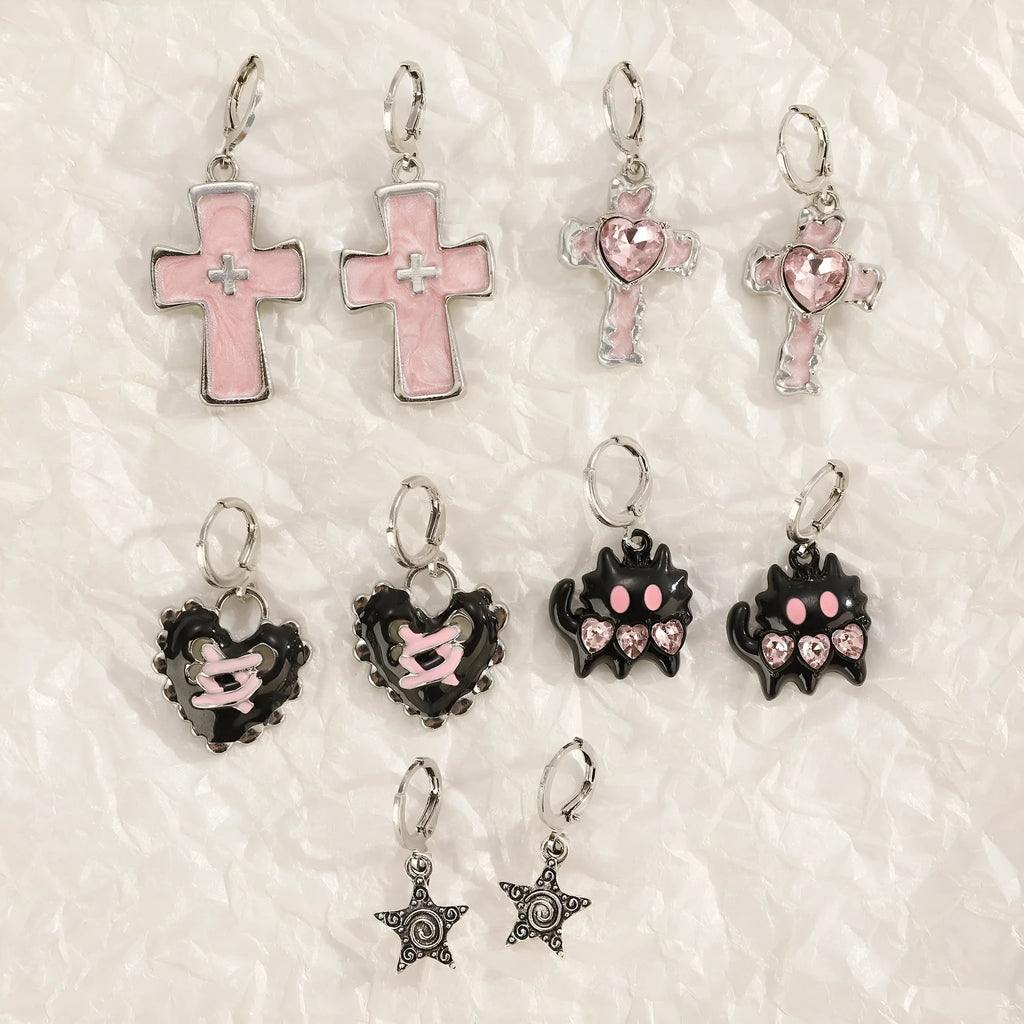 Women's alloy earrings showing cross, heart, and cat designs in white, black, and antique silver finishes.