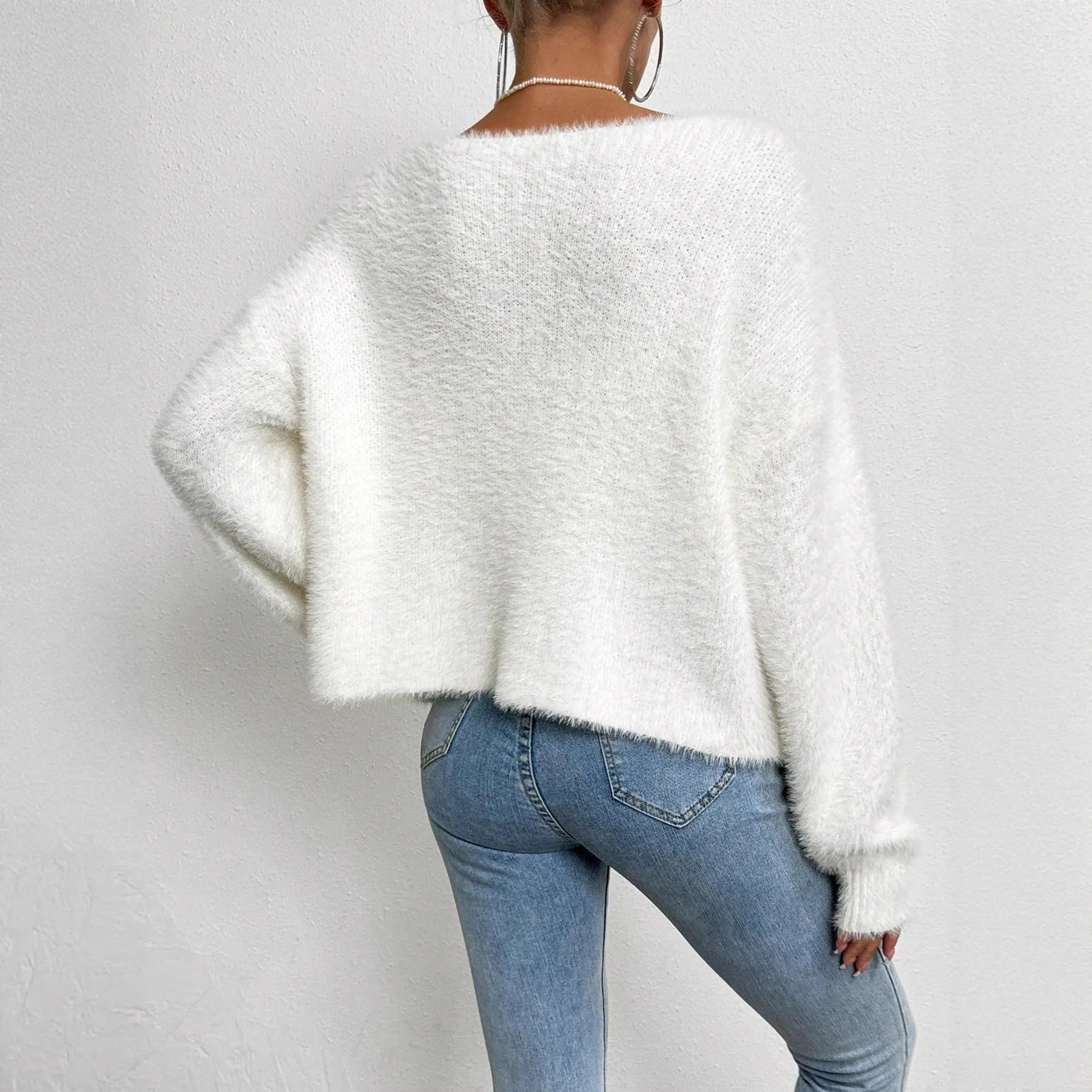 White women's V-neck cardigan with regular length polyester knit construction