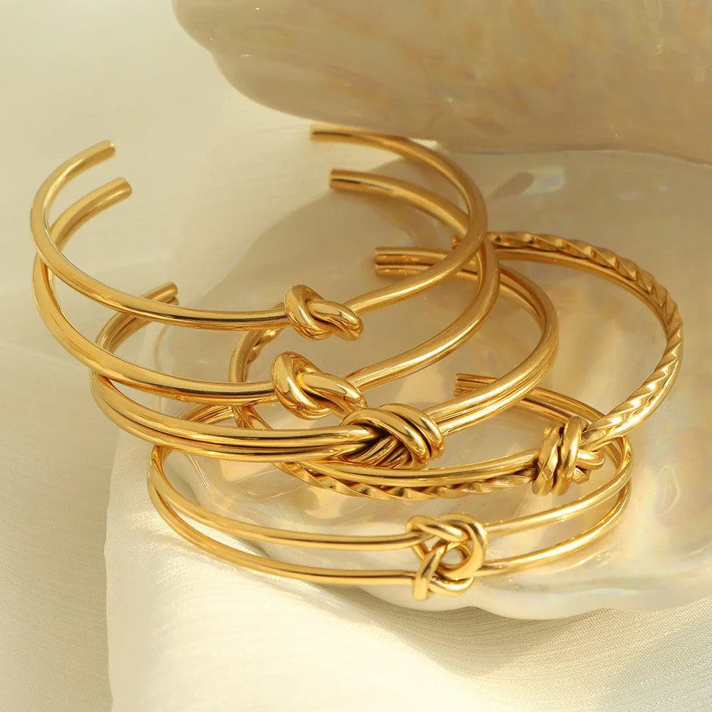 Stainless steel women's bracelet with knotted C-shaped open design and double-layer construction in gold or silver