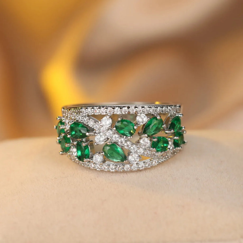 Women's round hollow fashion ring in gold or platinum with a white diamond or navy blue sapphire stone.