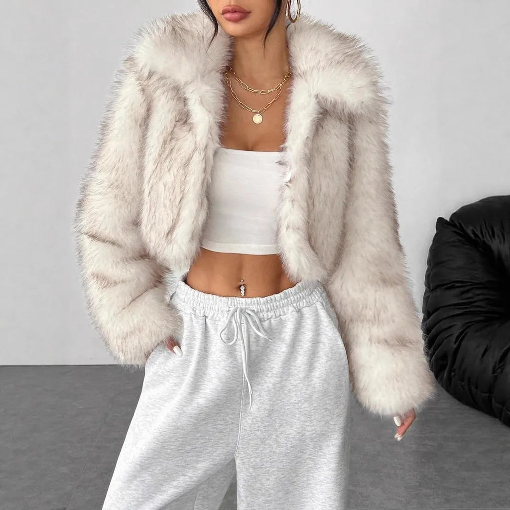 Women's short length artificial fur coat with a fur collar in a black tip on black background colour.