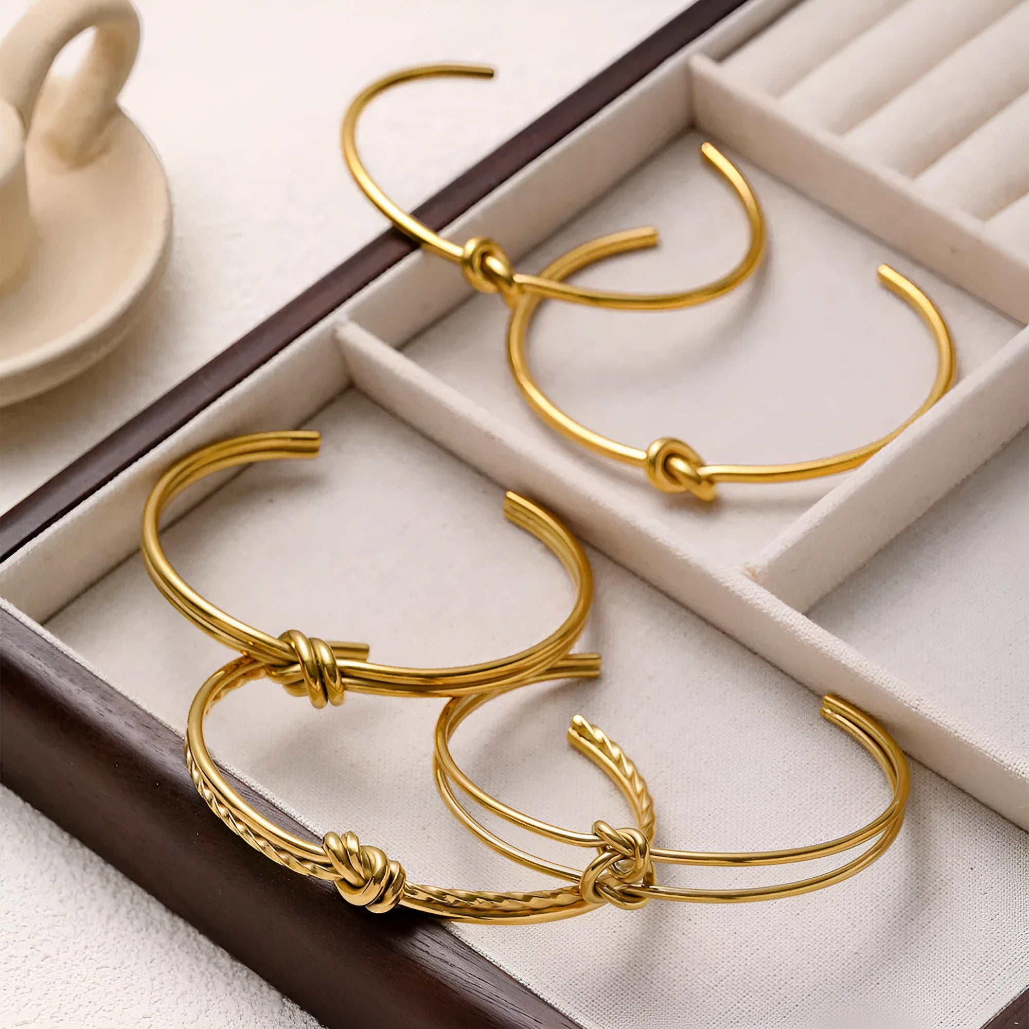 Stainless steel women's bracelet with knotted C-shaped open design and double-layer construction in gold or silver