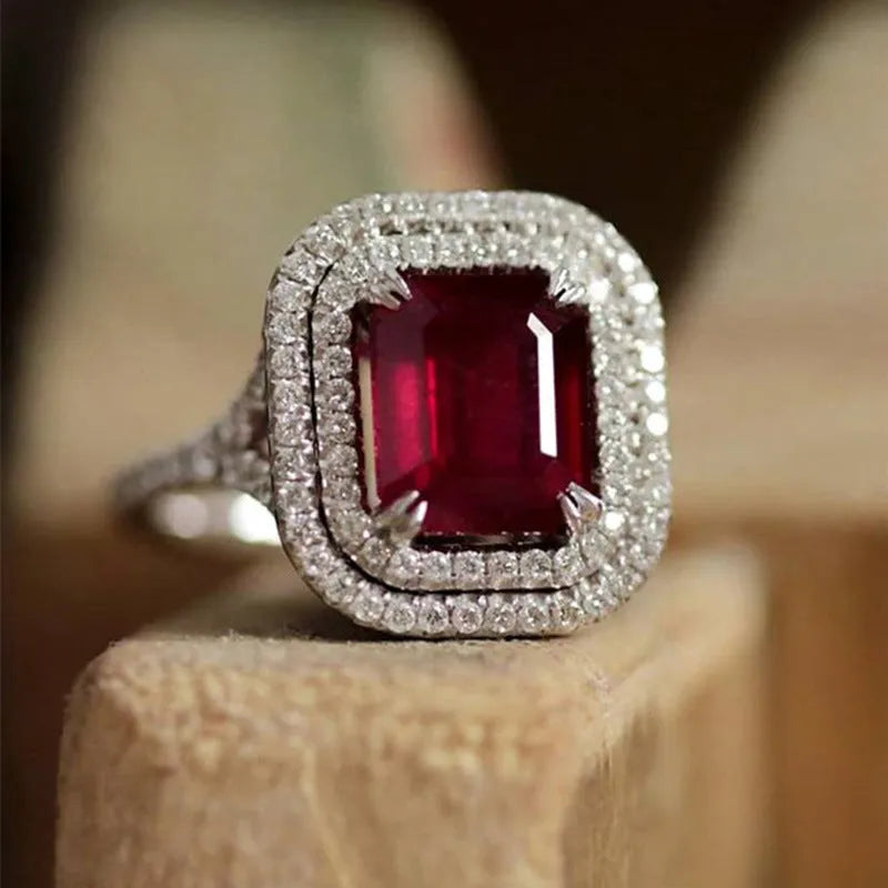Red geometric square copper women's ring with a central princess stone setting.