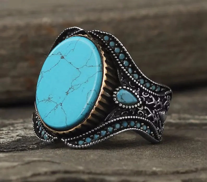 Men's round turquoise alloy ring in antique silver finish on size chart showing UK sizes 6 to 13