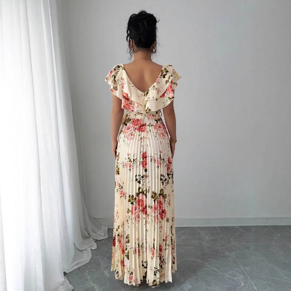 Apricot coloured floral print V-neck dress with ruffle sleeves and a flowing swing skirt.