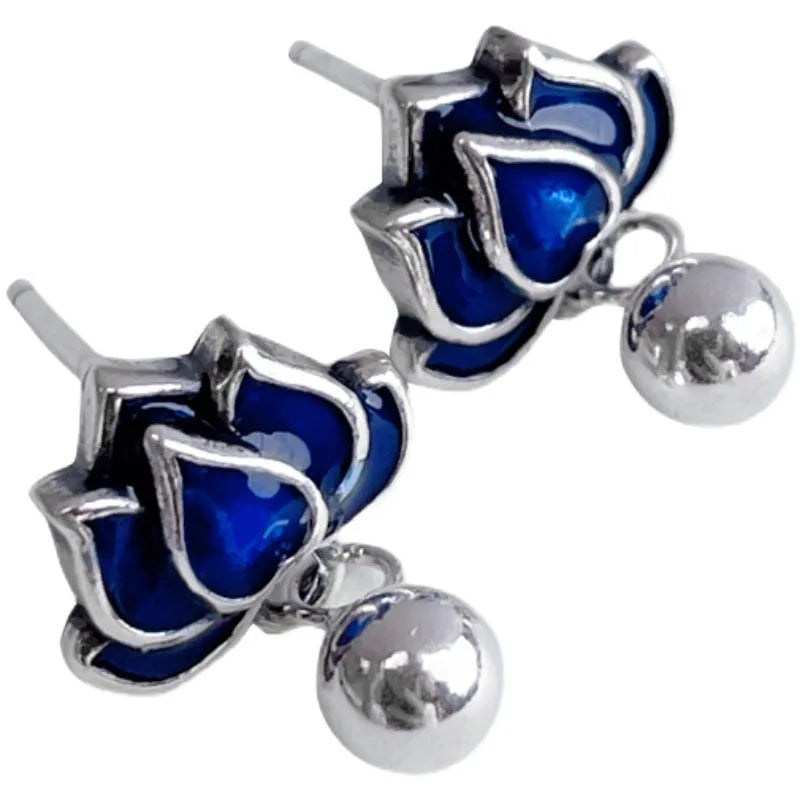 Blue lotus ear studs with seedpod tassel design and retro artistic style