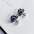 Blue lotus ear studs with seedpod tassel design and retro artistic style