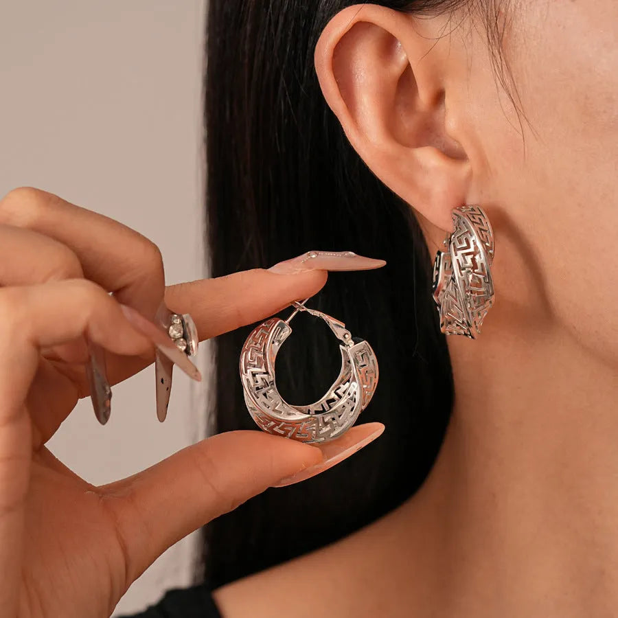 Geometric hollow stud earrings with twisted round design in gold or silver electroplated finish