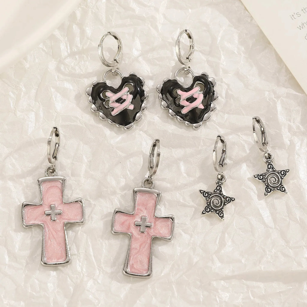 Women's alloy earrings showing cross, heart, and cat designs in white, black, and antique silver finishes.