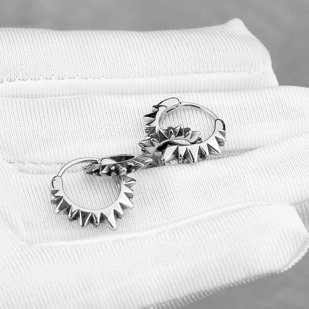Polished stainless steel retro hoop earrings with round ring design in steel colour.
