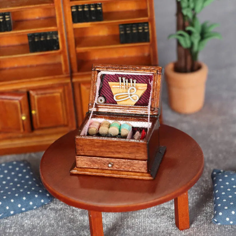 Small vintage sewing machine miniature ornament in a birch wood box with accessories.