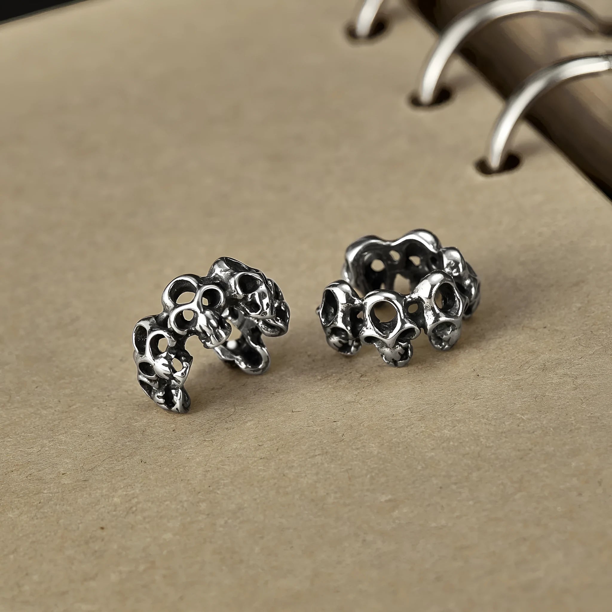 Stainless steel skull ear clips with hollow geometric design and electroplated metallic finish