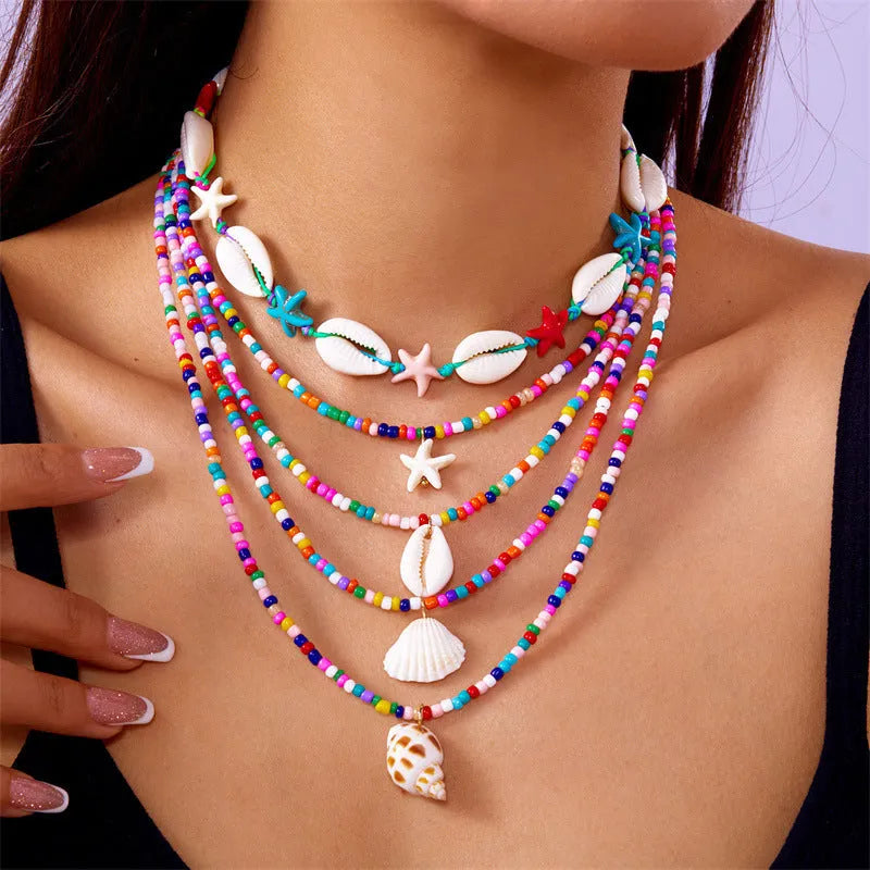Five women's necklaces with shell and conch bead pendants on adjustable electroplated alloy chains
