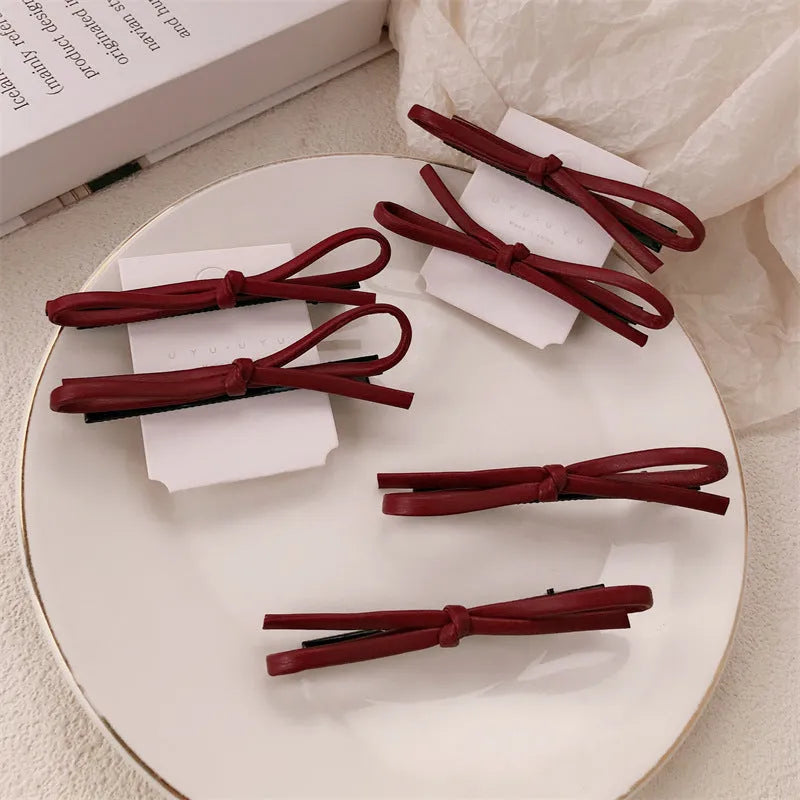 Wine red leather bow barrettes hair clips for women, available singly or in pairs