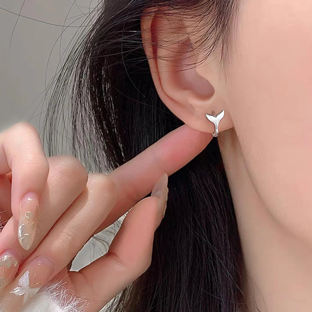 A pair of simple fishtail design earrings in a choice of white gold or yellow gold colour.