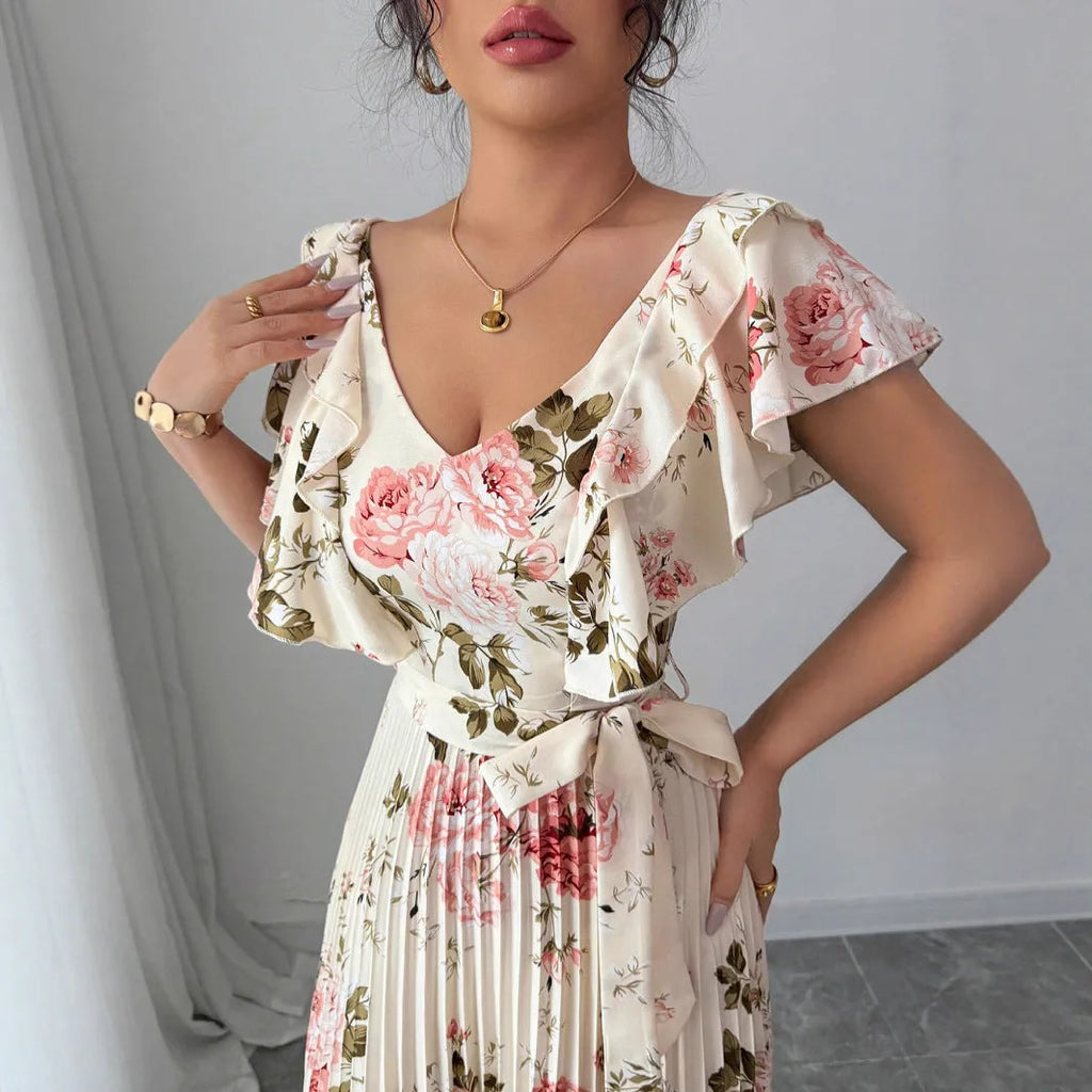 Apricot coloured floral print V-neck dress with ruffle sleeves and a flowing swing skirt.