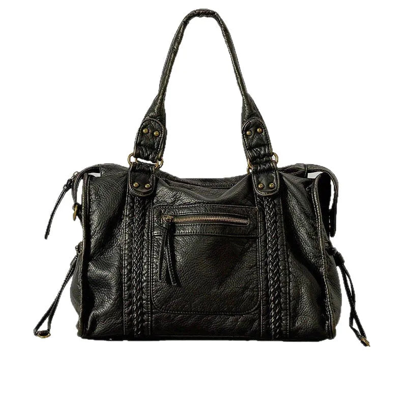 Women's retro motorcycle style messenger bag in bright black with golden edge, showing internal zipper compartments and single shoulder strap