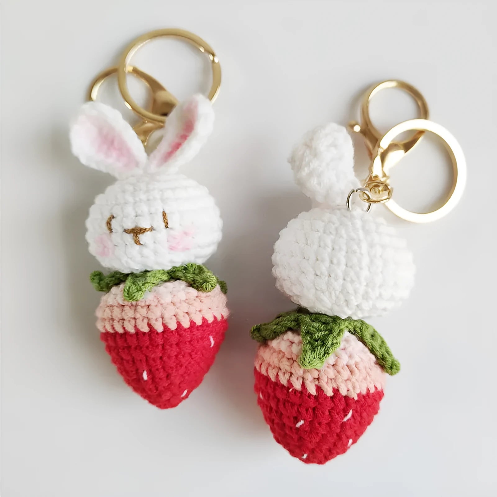 White hand-woven rabbit strawberry wire pendant with key on a white background
