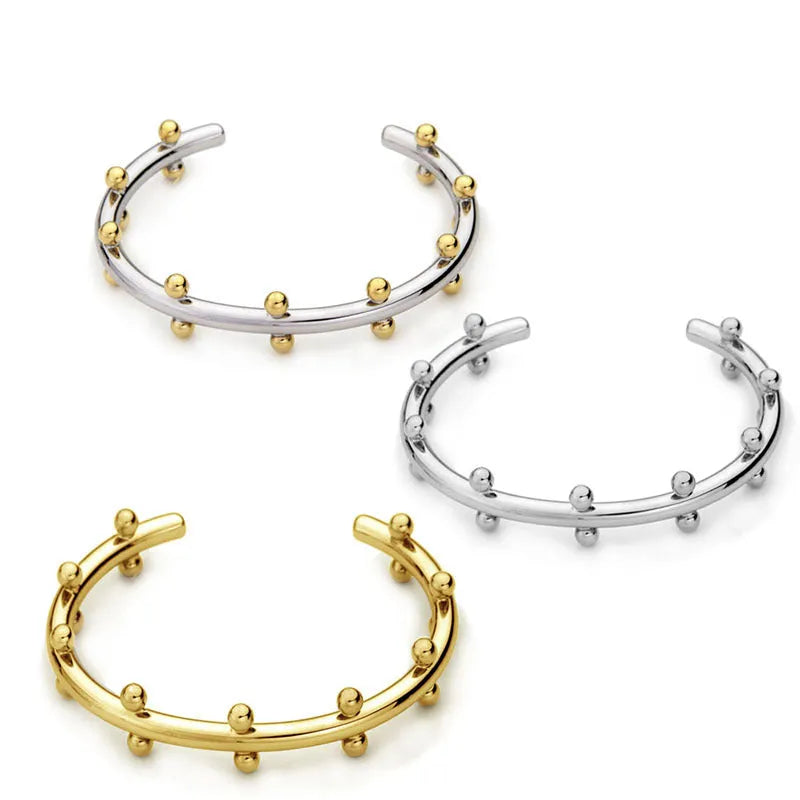 Stainless steel C-shaped bean bead charm with round rivet texture, shown in gold, steel, and steel gold colours.