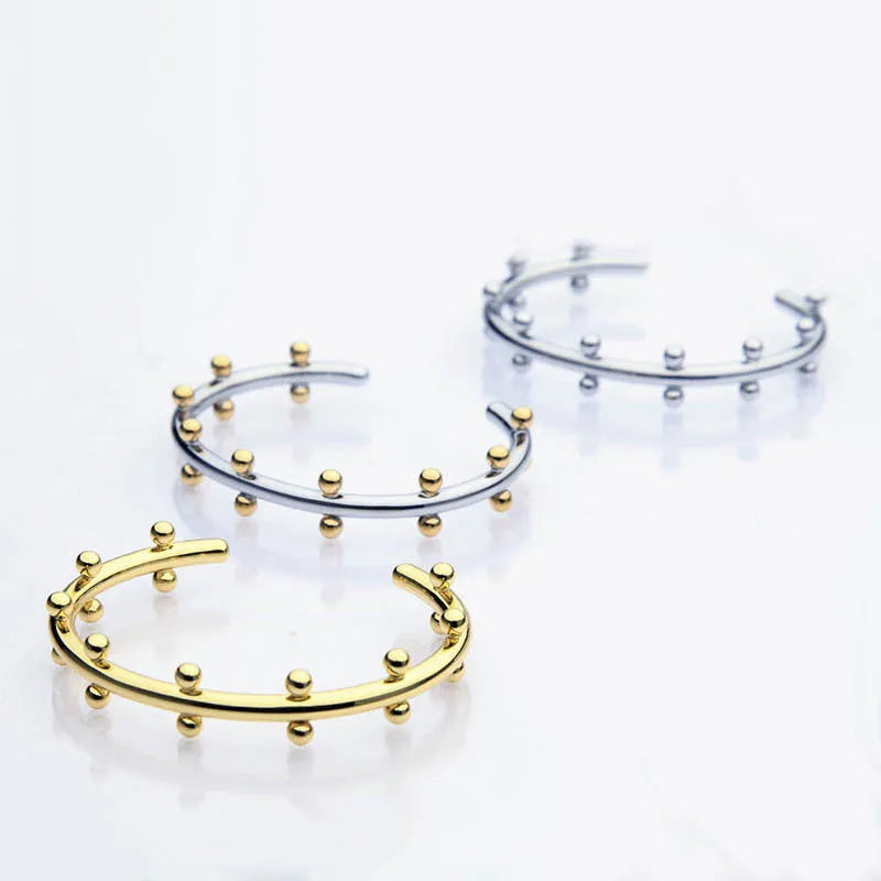 Stainless steel C-shaped bean bead charm with round rivet texture, shown in gold, steel, and steel gold colours.
