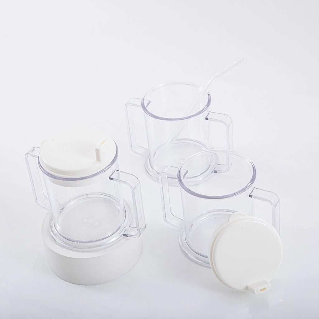 Transparent plastic drinking cup with a black spill-proof lid on a white background