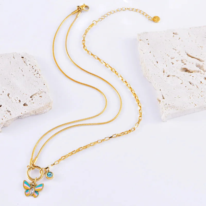 Gold titanium steel butterfly necklace and bracelet set with epoxy colour detailing on animal zodiac pendant