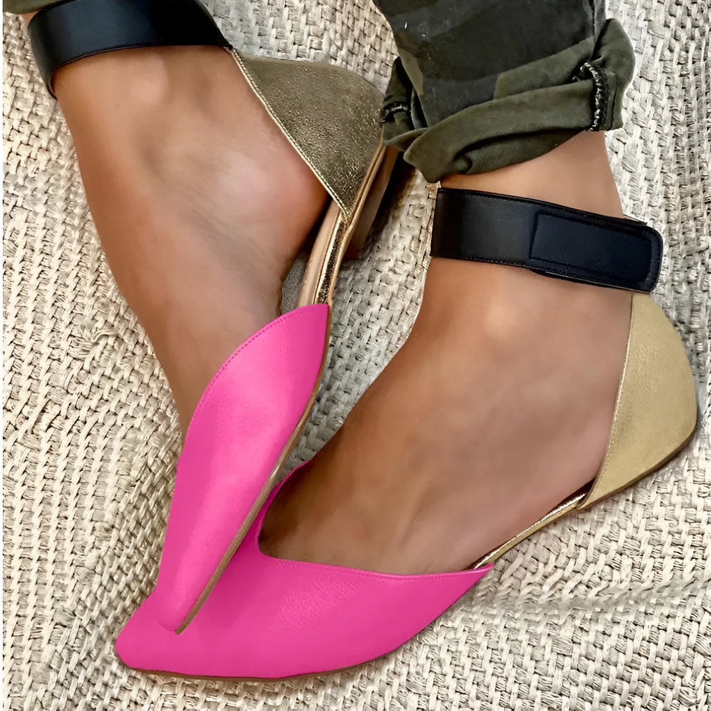 Women's beige velcro sandals with hollowed design and flat heel, shown on a white background.