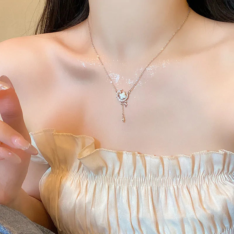 Gold celestial necklace with star and moon pendant on delicate clavicle chain