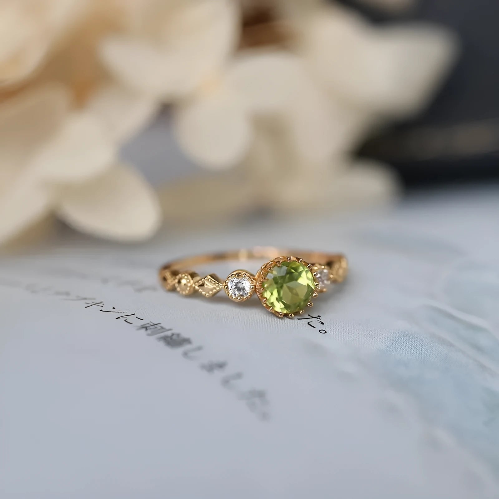 Japanese style geometric copper ring with imitation peridot stone on a model's finger.