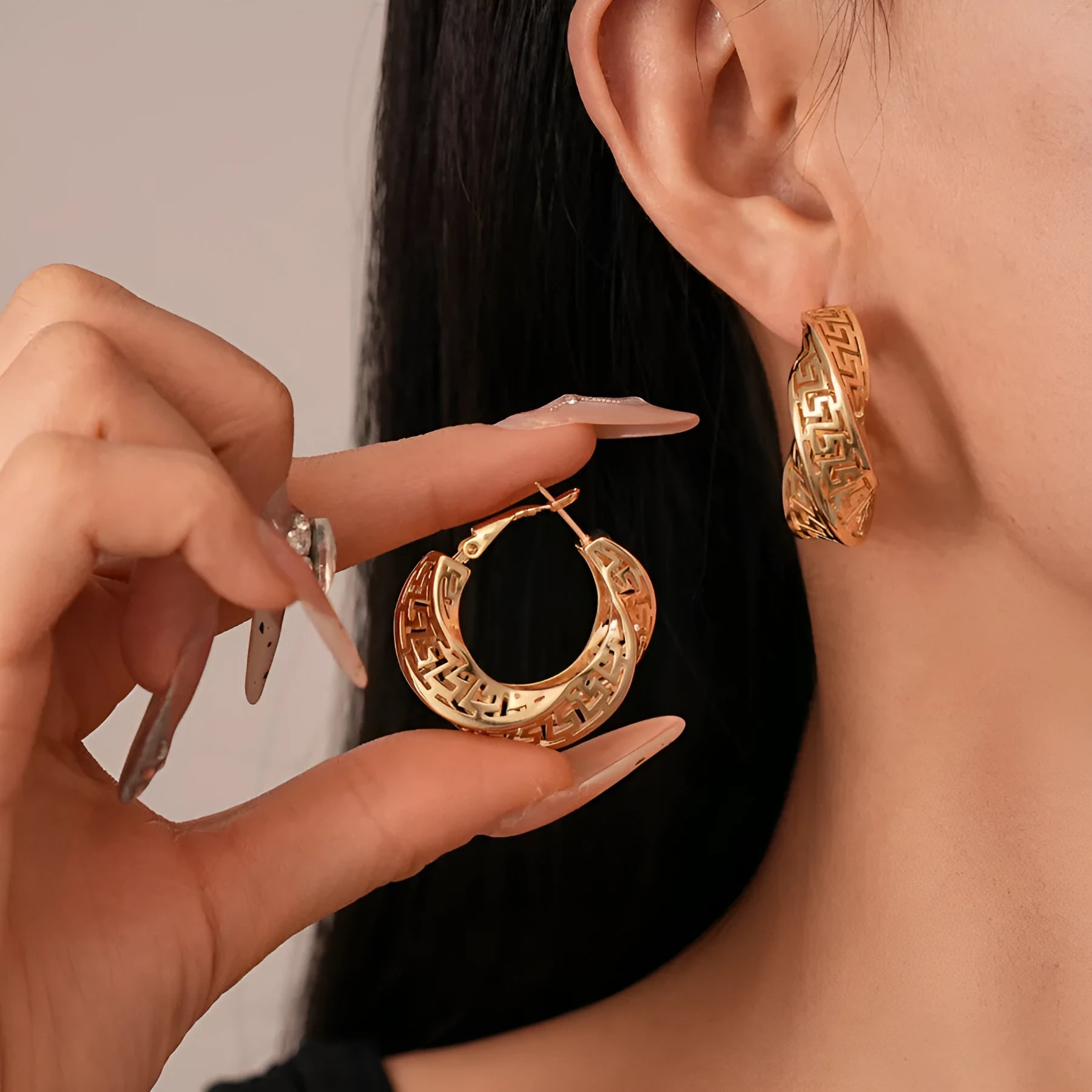 Geometric hollow stud earrings with twisted round design in gold or silver electroplated finish