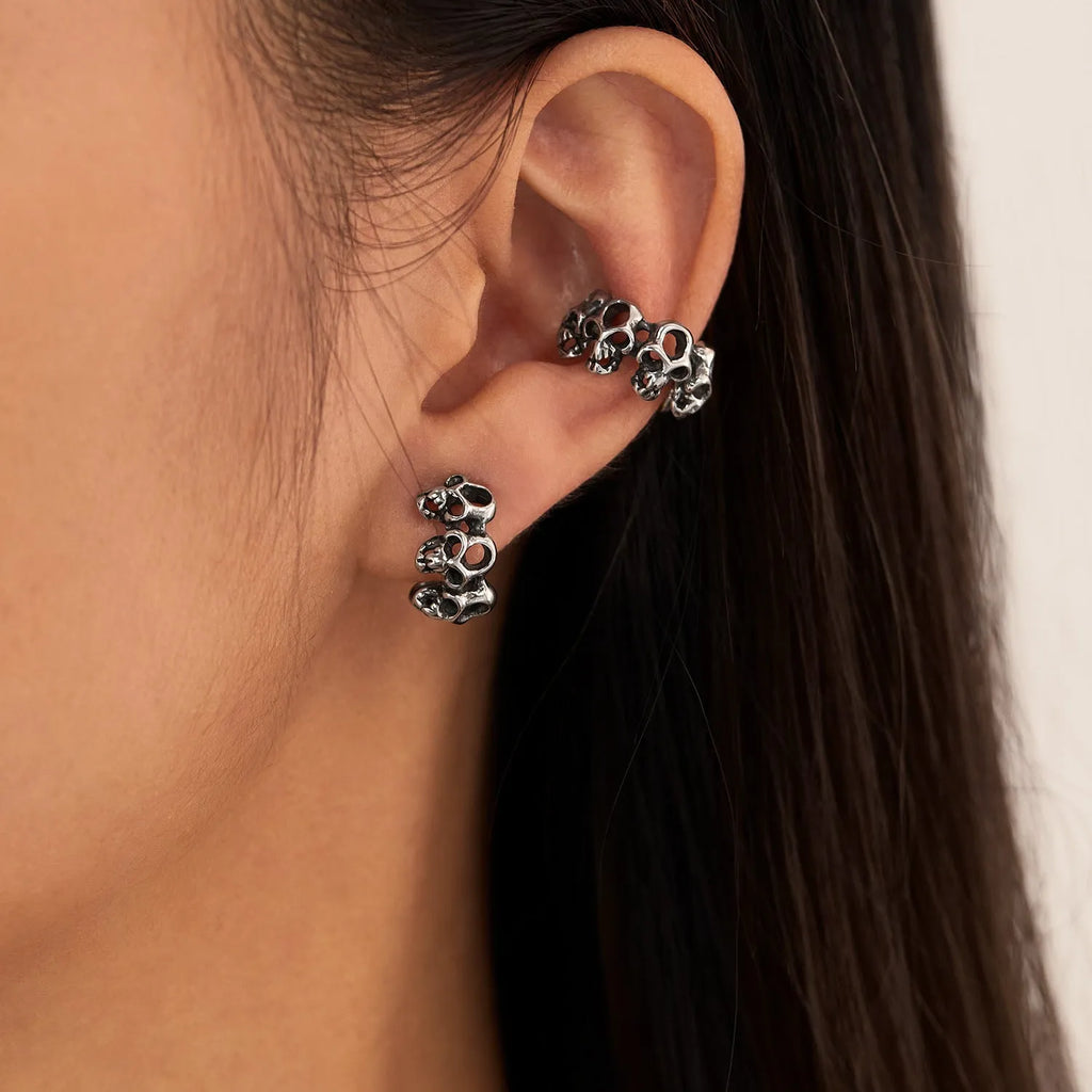 Stainless steel skull ear clips with hollow geometric design and electroplated metallic finish