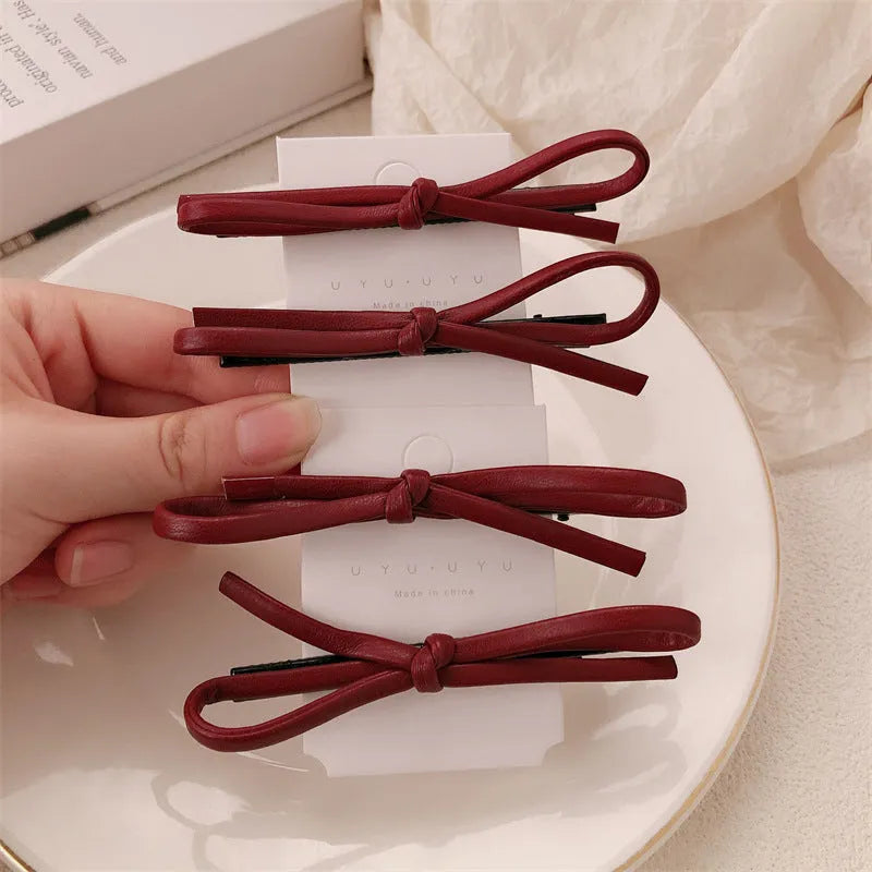 Wine red leather bow barrettes hair clips for women, available singly or in pairs