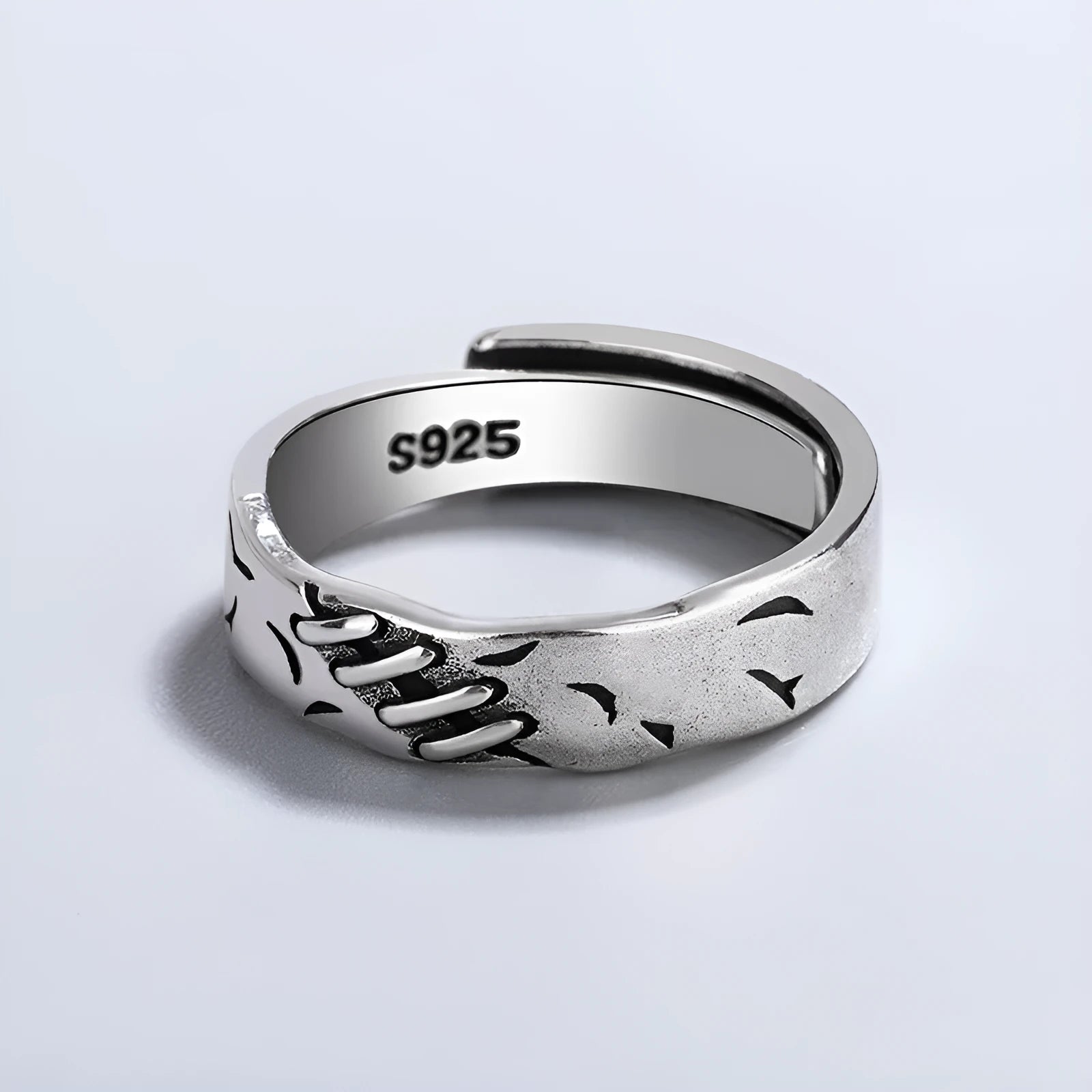 Black geometric copper ring with an adjustable opening on a white background.