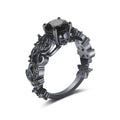 Unisex copper punk electroplated black gold ring with inlaid black zircon stone and olive branch motif on black background