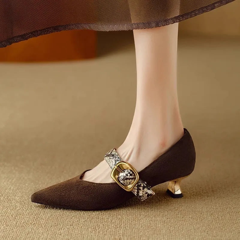Women's black pointed toe stiletto heels with a buckle fastening on the side