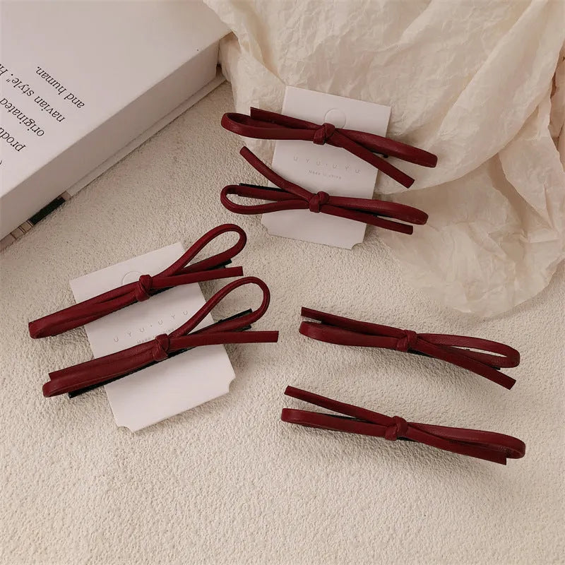 Wine red leather bow barrettes hair clips for women, available singly or in pairs