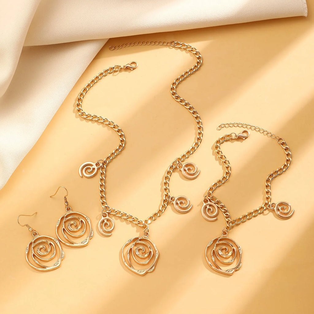 Spiral donut design women's jewellery set showing matching necklace, bracelet, and ear hooks in gold electroplated finish