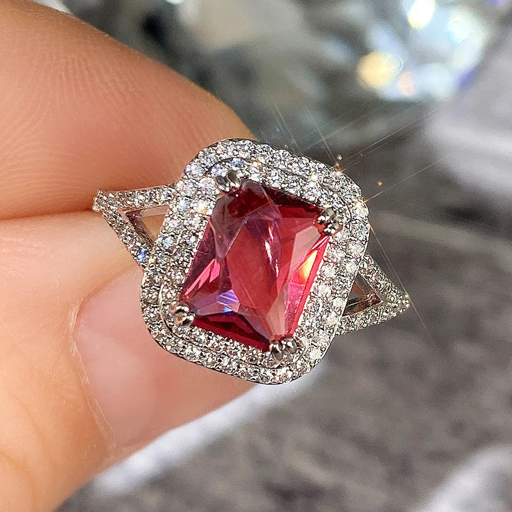 Red geometric square copper women's ring with a central princess stone setting.