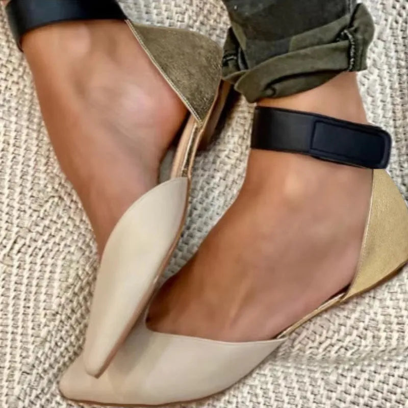 Women's beige velcro sandals with hollowed design and flat heel, shown on a white background.